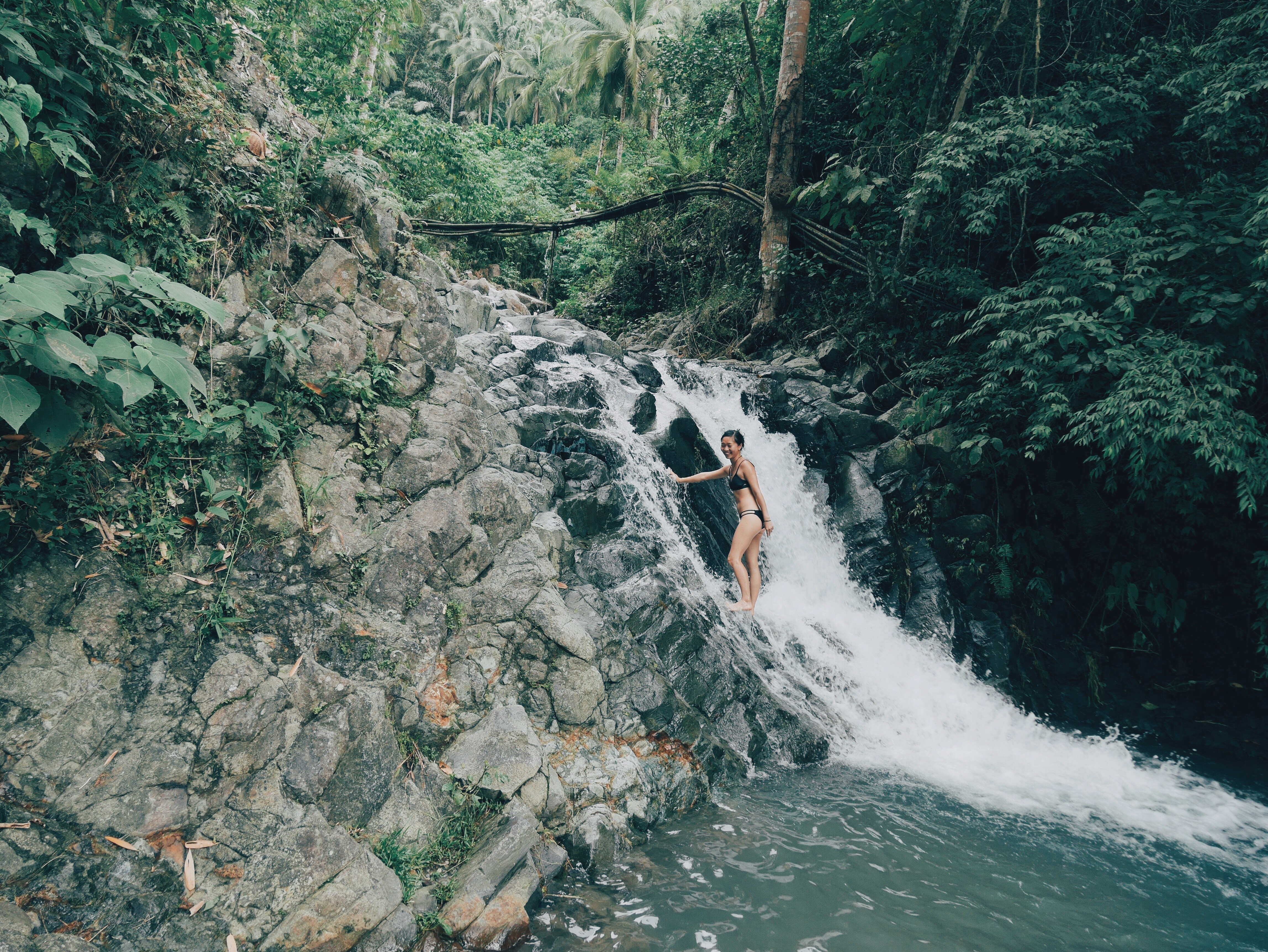 A girl climbing on a small waterfall